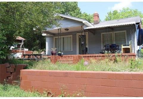Charming residential home alongside a commercial building.