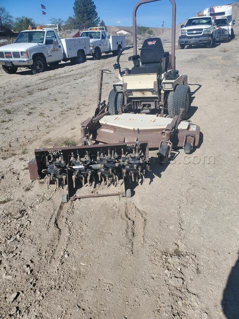 Grasshopper with mower and aerator attachments